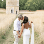 Bride and groom kissing in front of the Pigeonnier at domaine de la leotardie Dordogne photo by Anneli Marinovich