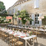 central courtyard with 3 long tables for a wedding dinner at domaine de la Leotardie photo by Anneli Marinovich