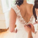 person closing the dress of a bride at le domaine de la Leotardie photography by Claire Penn